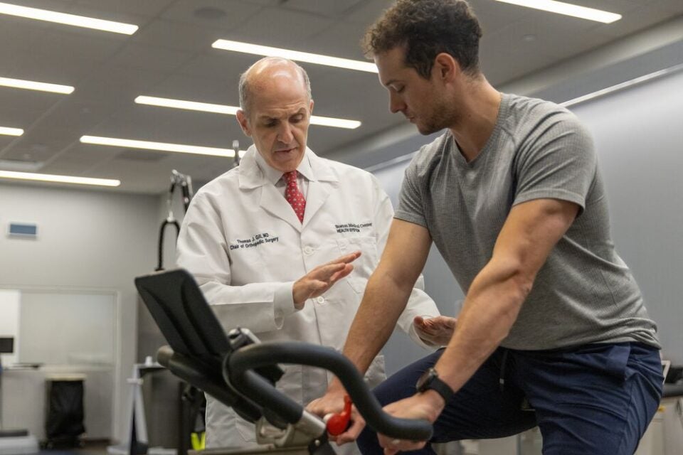 Dr. Thomas Gill works with a patient at the BMC Brighton Sports Medicine Service