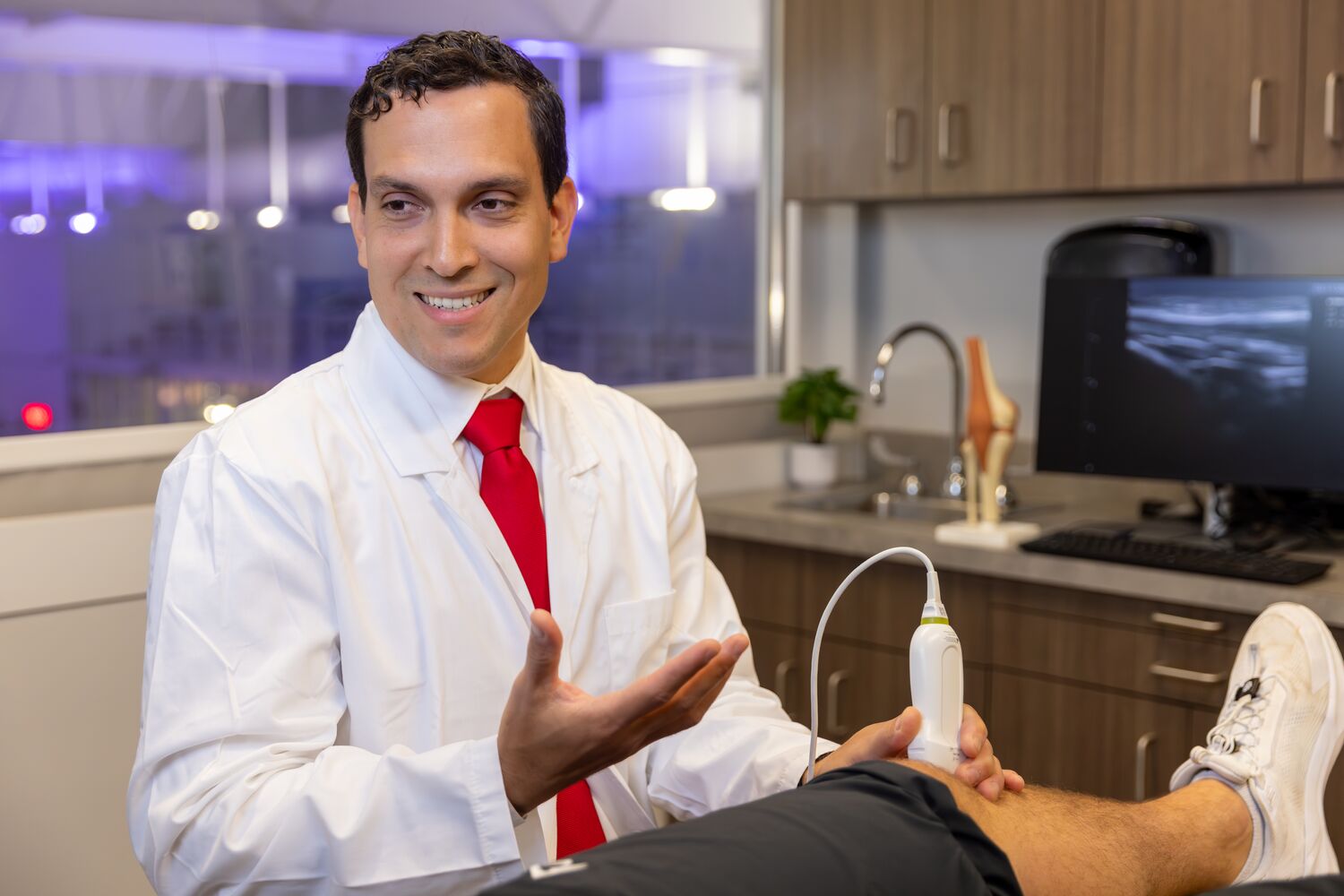 Dr. Brian M. Cervoni Rosario works with a patient at the BMC Sports Medicine Center