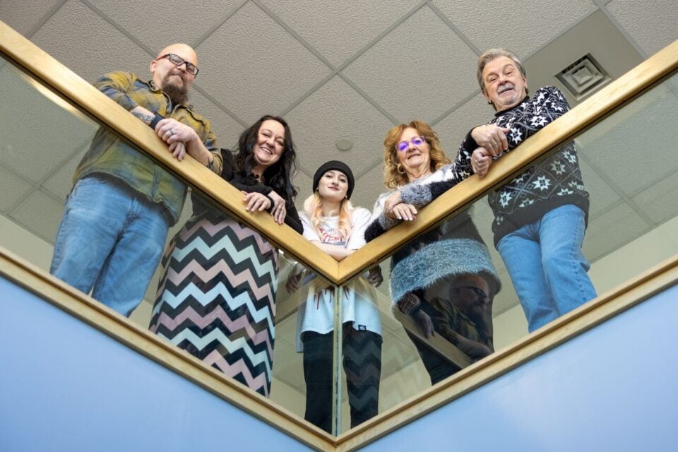 Three generations of a family served by BMC Brighton cardiologist David Goldberg look down from a hospital railing