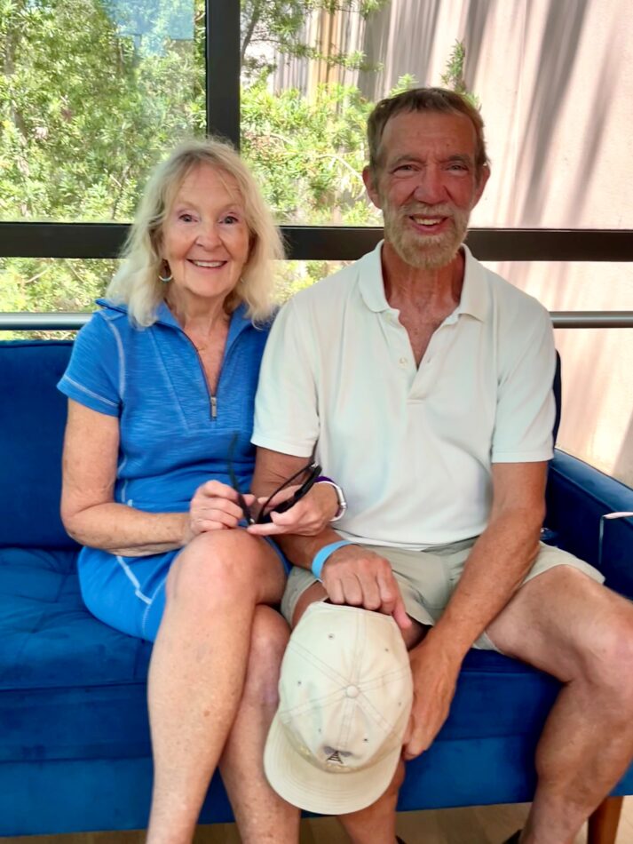 Stephen Cloutier sits smiling next to his wife, Eliza Duade