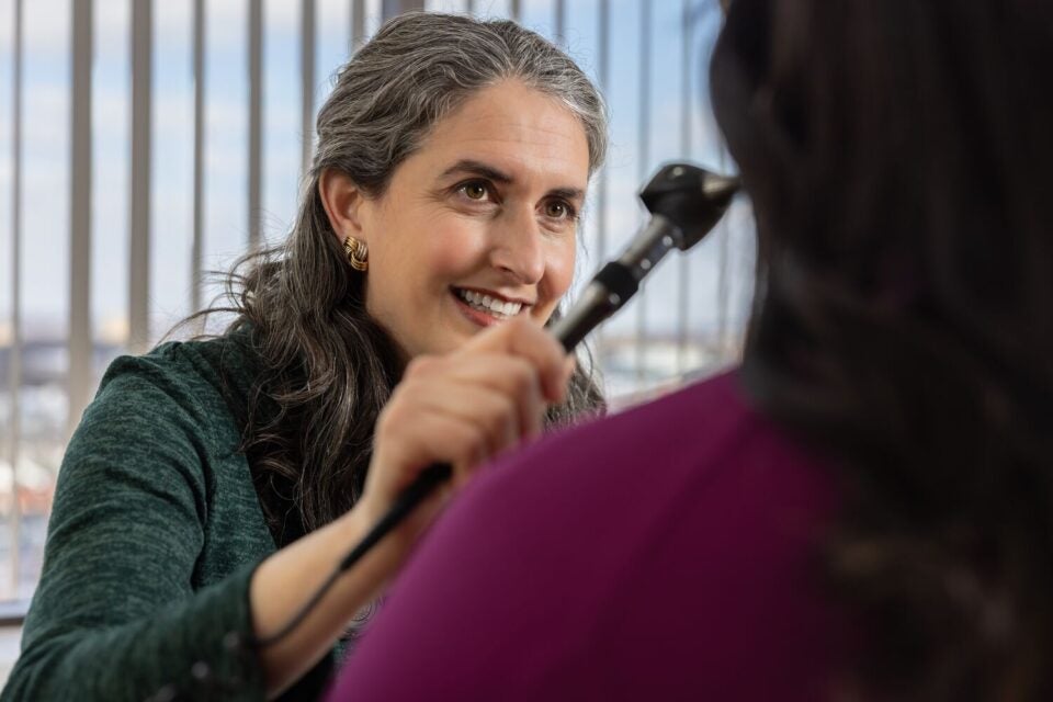 Large-2026_Erica Mintzer_Clinic Space0947-Edit_JF Erica Mintzer, MD, family medicine physician at BMC Brighton Primary Care, examines a patient’s eyes