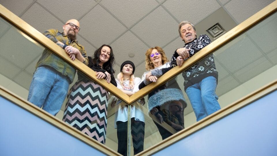 Three generations of a family served by BMC Brighton cardiologist David Goldberg look down from a hospital railing (16x9 crop)