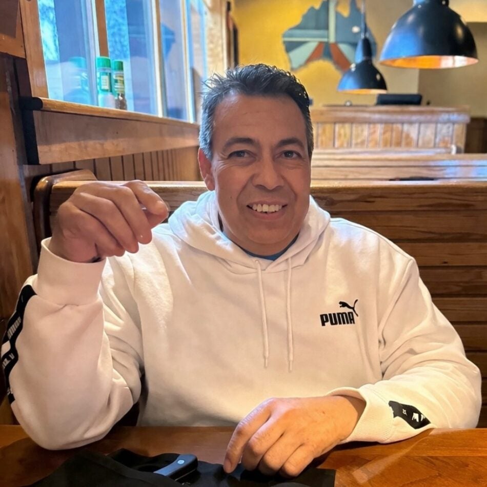 BMC Brighton patient Trinidad Barrios smiles as he sits at a restaurant table