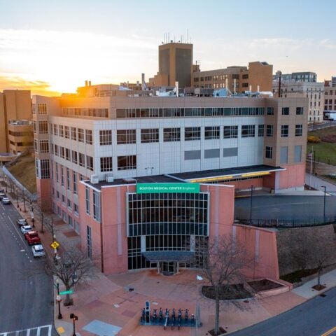Aerial photo of BMC Brighton (hospital building exterior) at sunset