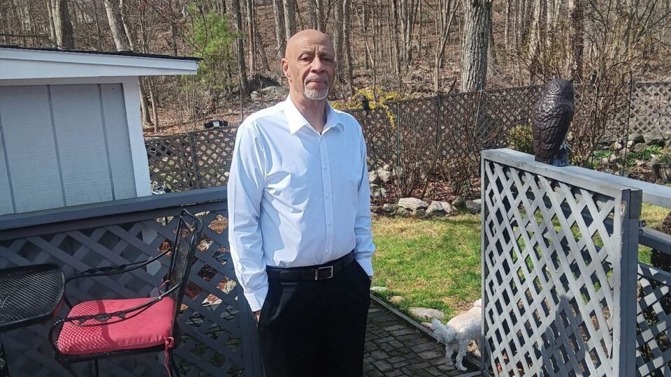 BMC and BMC Brighton esophageal cancer patient Stanley Mattox stands in his yard on a sunny day
