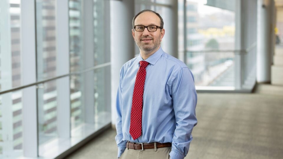 Mark H. Katz, MD, urologist at Boston Medical Center, standing in a sunlit hallway that overlooks downtown Boston (16x9 crop)