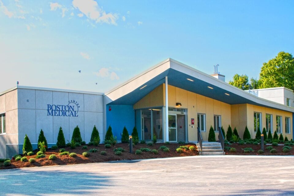 Exterior of the Brockton Behavioral Health Center building, a low-slung, modern building with an angled awning over the front entrance and a prominent BMC logo